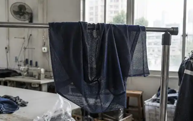 Fine sports mesh held against window daylight