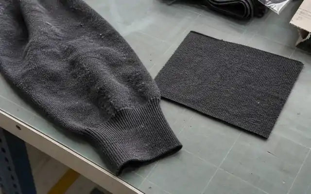 Worn knit surface with pilling beside a cleaner fabric sample