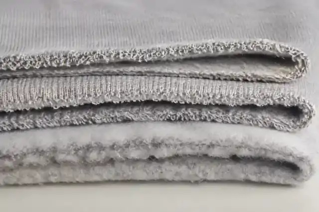 Folded fleece fabric layers showing brushed and loopback textures