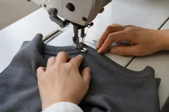 Close-up of a sample neckline being sewn at a sewing machine