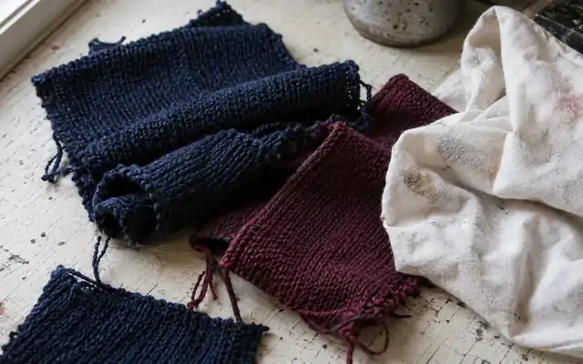 Colored fabric scraps beside a stained white rubbing cloth