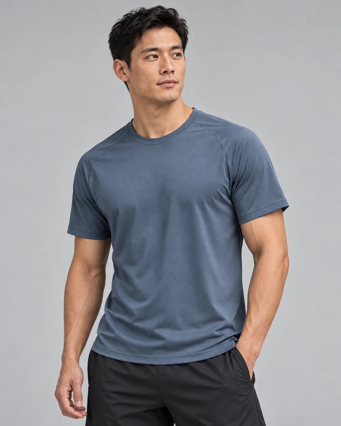 Male model wearing a slate-blue short-sleeve performance top