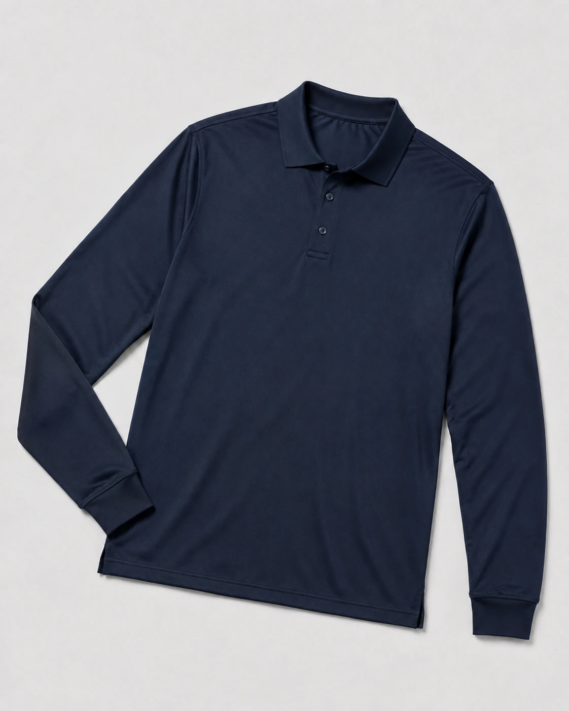 Long-sleeve performance polo with ribbed cuffs and a clean button placket on a neutral studio background