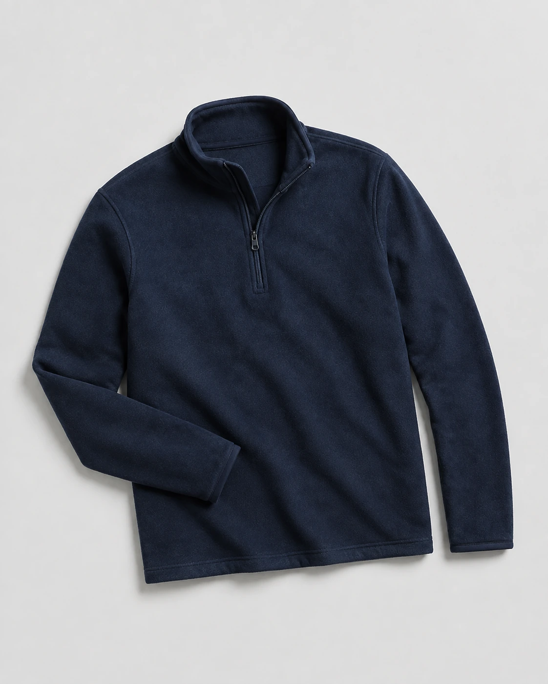 Navy quarter-zip fleece midlayer laid flat to show collar, sleeves and hem