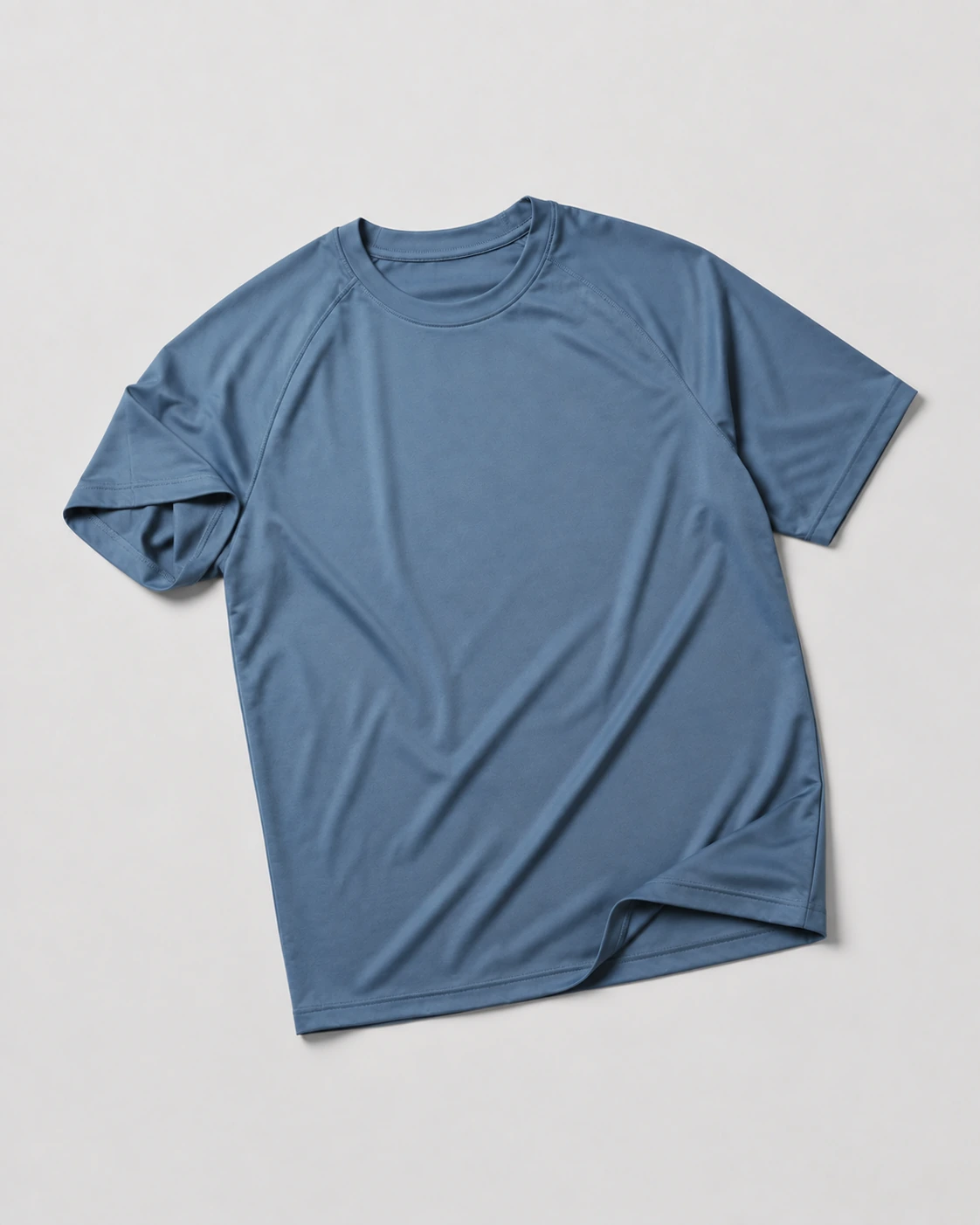 Slate blue performance crewneck T-shirt with fine knit texture on a light-grey studio background