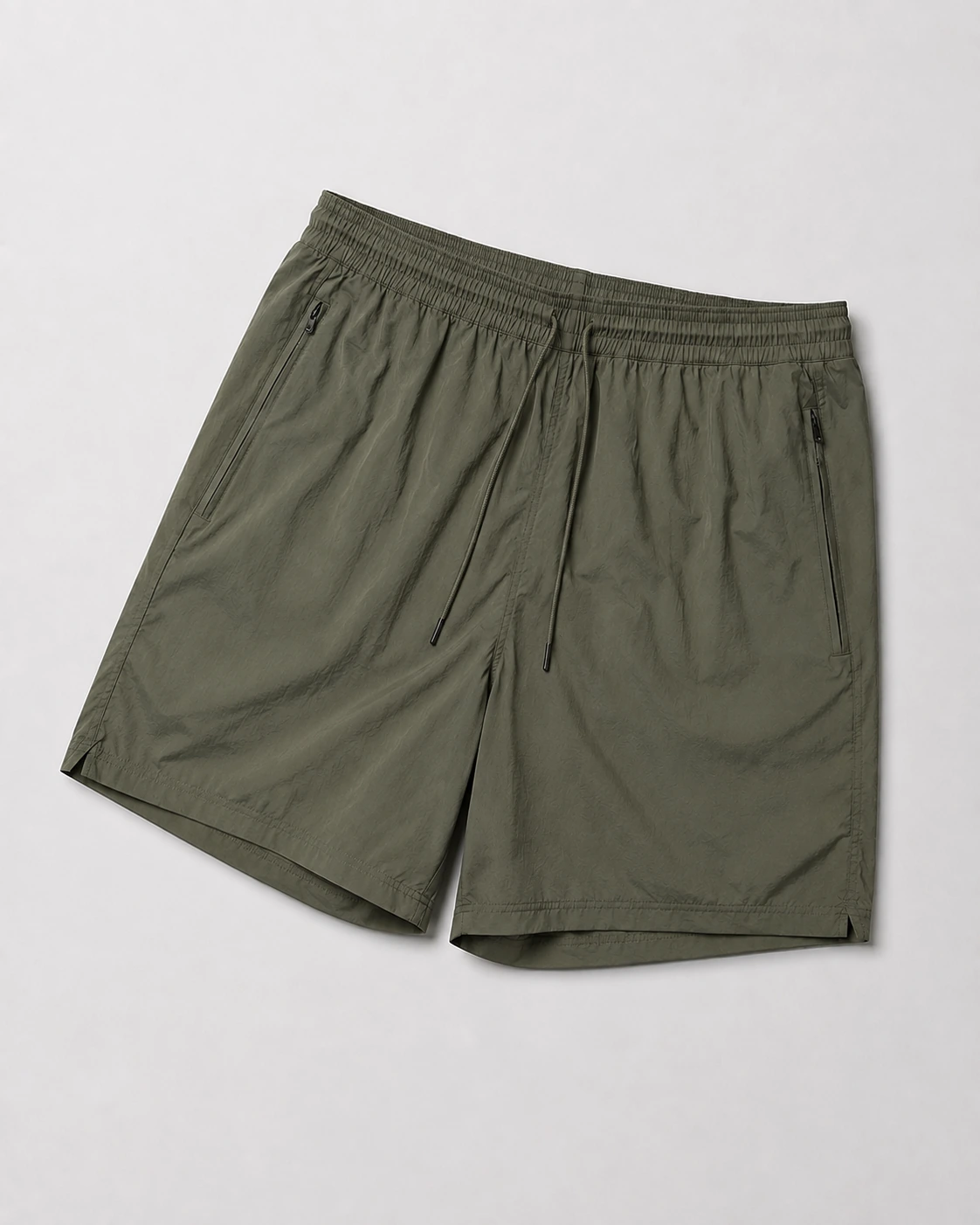 Olive training shorts with an elastic drawstring waist and pocket construction